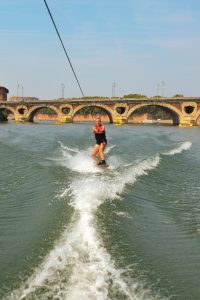 Pratique du ski nautique sur la Garonne à Toulouse, une activité sportive et nautique incontournable à faire en été en Occitanie.
